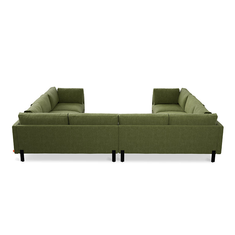 Green fabric U-shaped sectional sofa with clean lines and modern black legs seen from the back side.