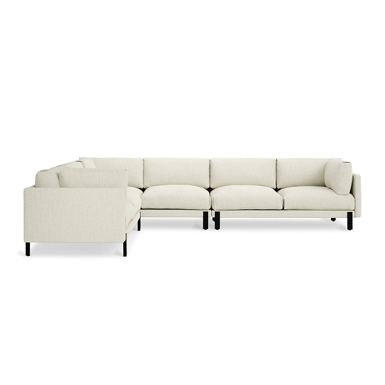 Cream-colored modern sectional sofa with clean lines and black legs, suitable for spacious living rooms.