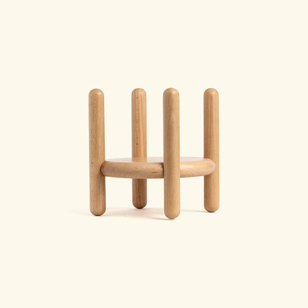 Wooden geometric sculpture on a beige background