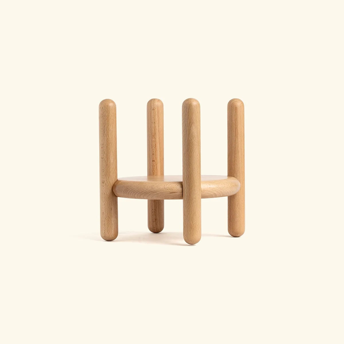 Wooden geometric sculpture on a beige background
