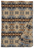 Beige, blue, and brown geometric patterned washable wool blanket with a folded corner showing its soft texture.