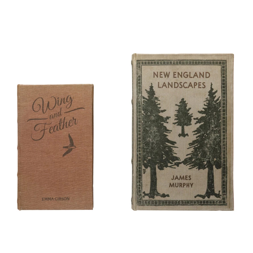 Two vintage-style books with textured covers, one titled New England Landscapes featuring tree illustrations