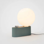 Compact modern table lamp with a dimmable round frosted white LED bulb and matte green base for home decor