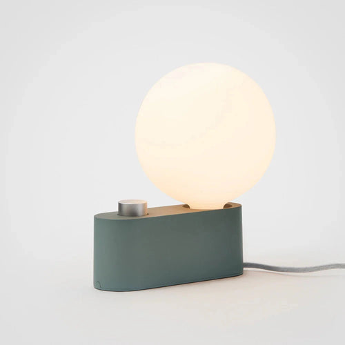 Compact modern table lamp with a dimmable round frosted white LED bulb and matte green base for home decor
