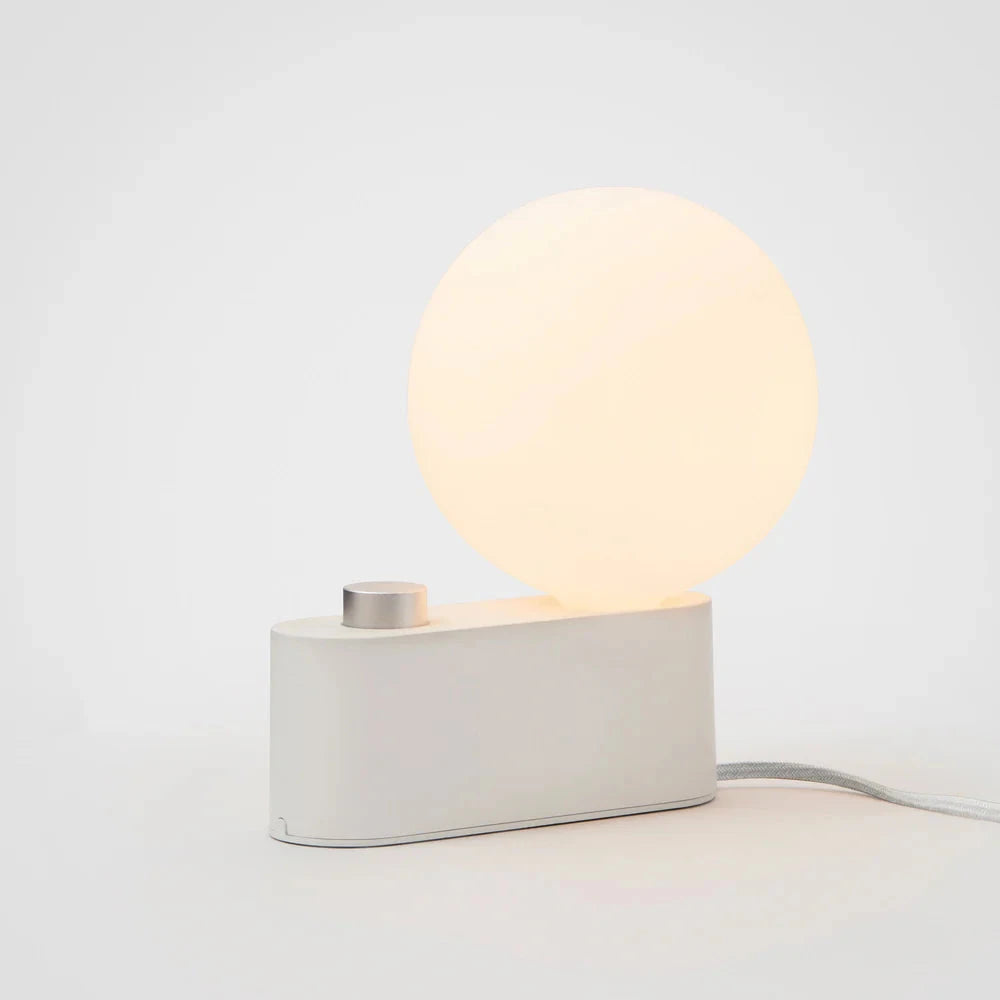 Minimalist white LED lamp with a round glowing dimmable light and rectangular base for modern home decor