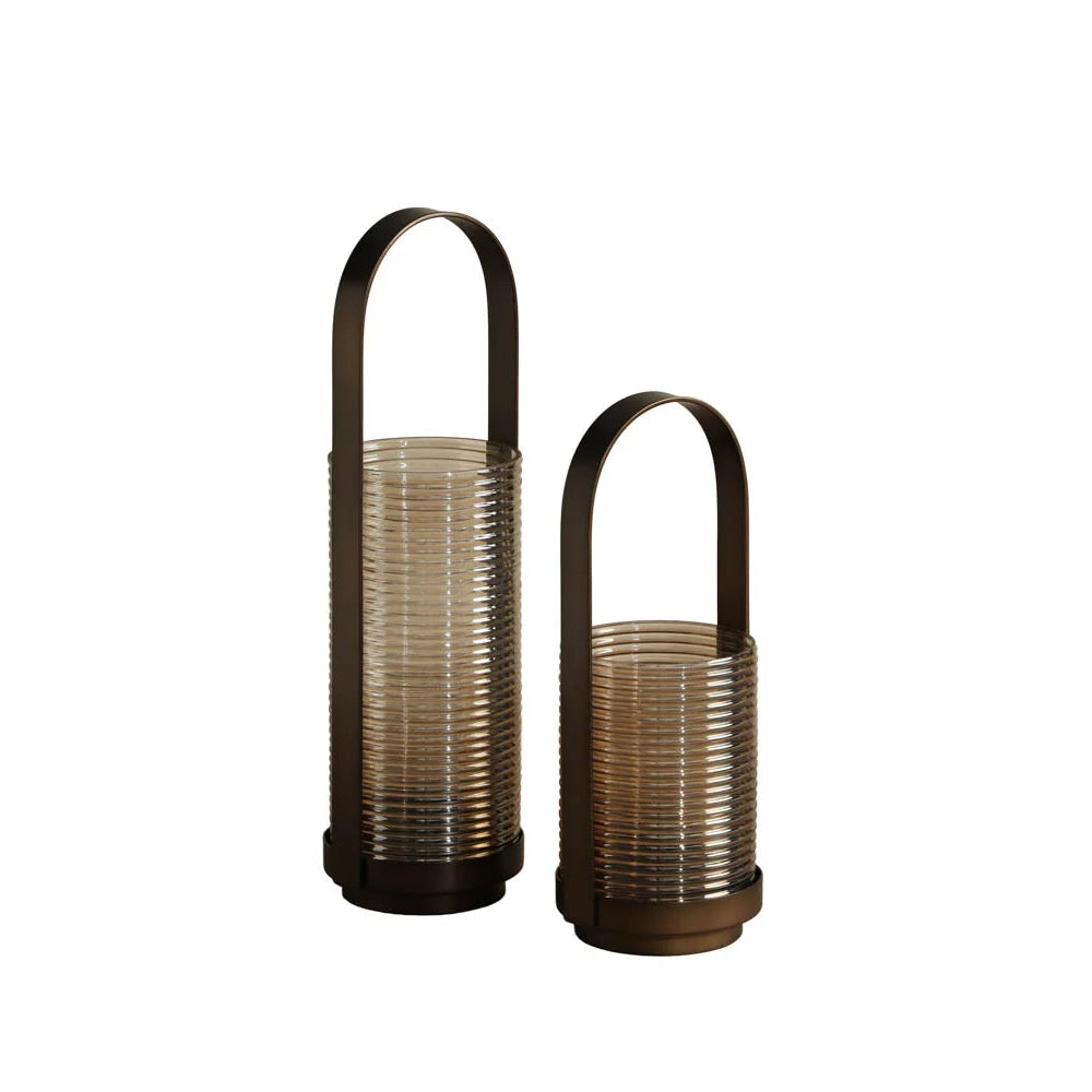 Two ribbed glass lanterns in a smoky translucent brown shade, one tall and one short, both with dark metal arched handles and bases, shown on a plain white background.