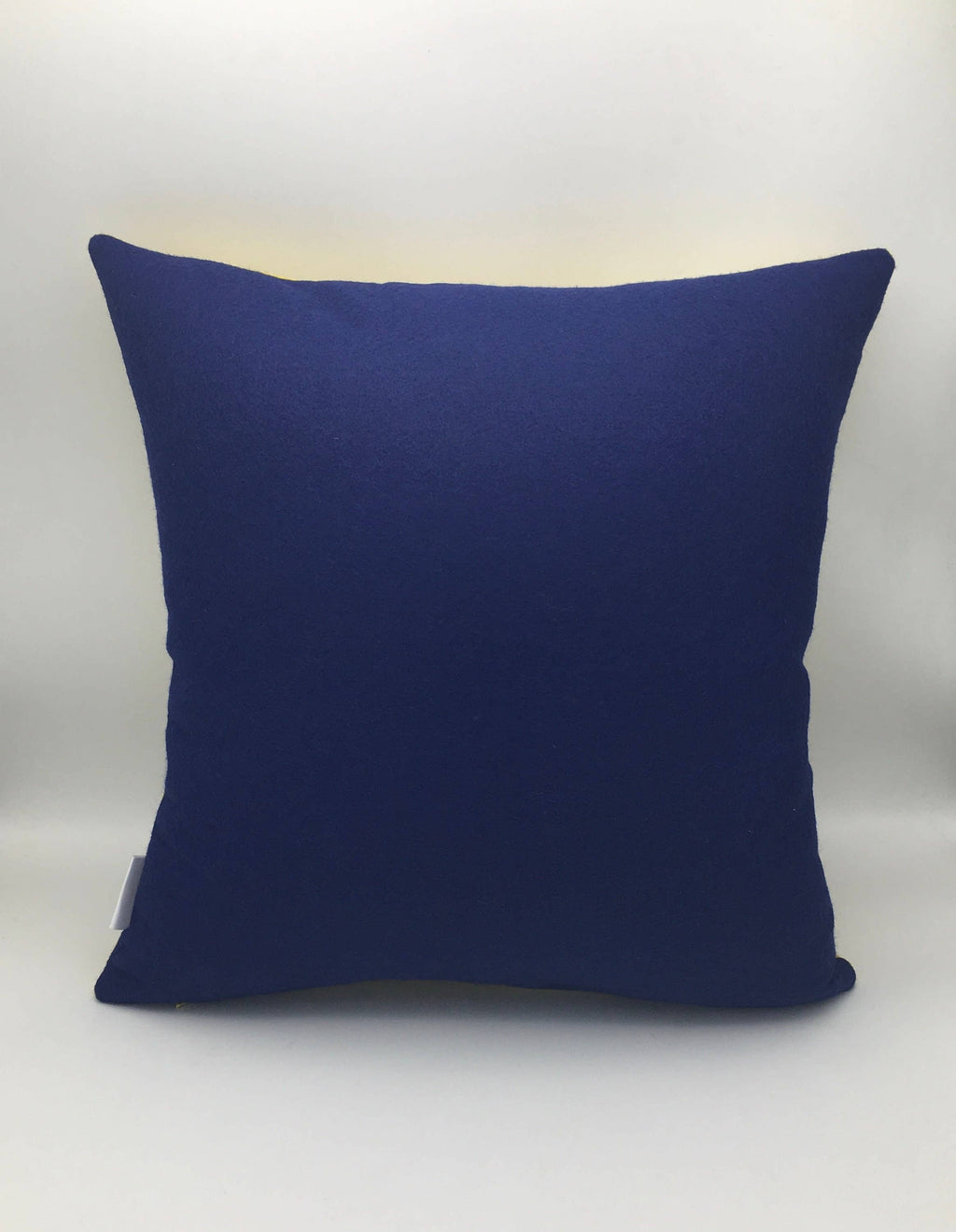 Square deep blue wool felt throw pillow with a soft texture, suitable for home decor and furniture accents
