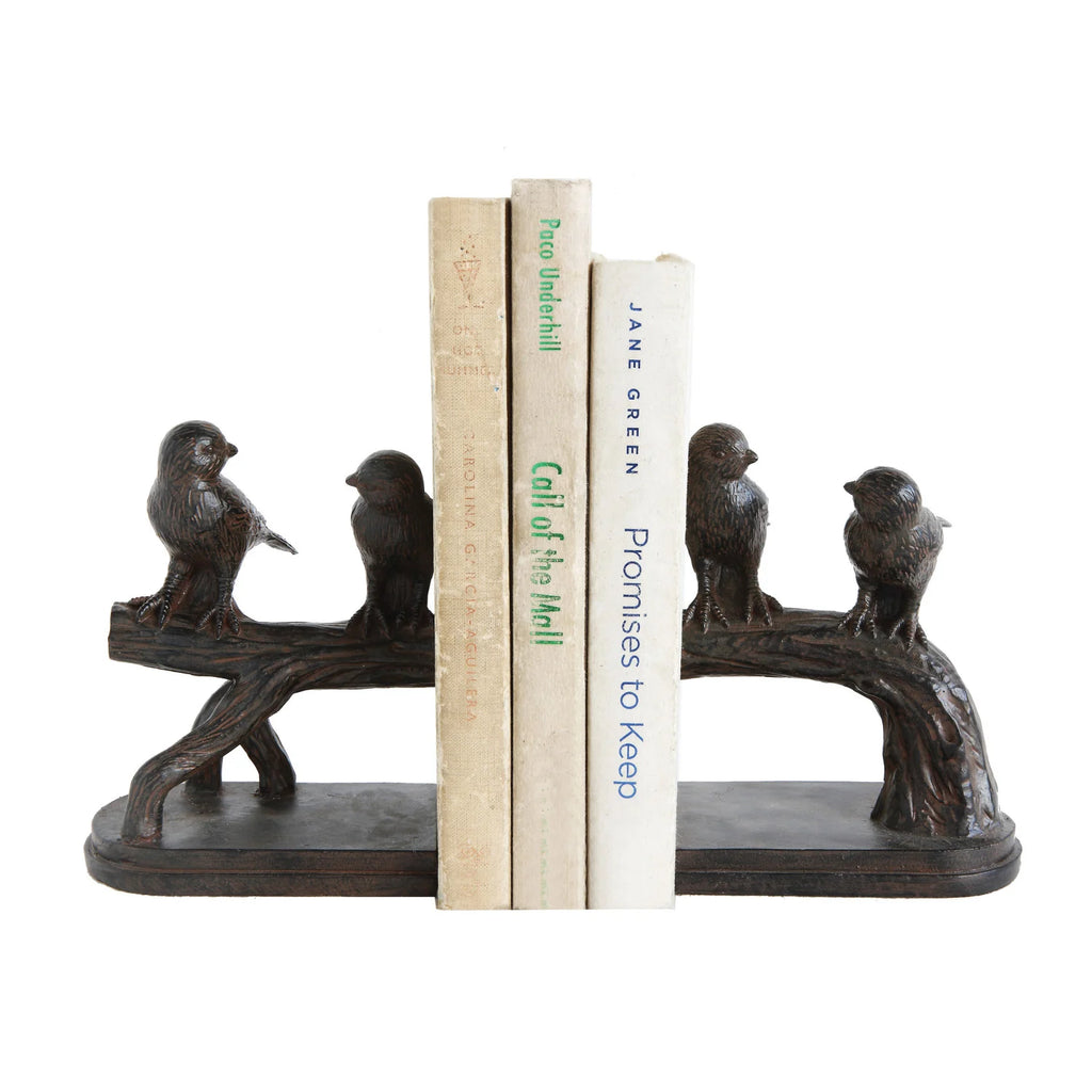 Bird-shaped bookends holding books on a white background