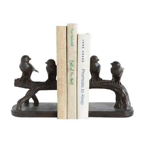 Bird-shaped bookends holding books on a white background