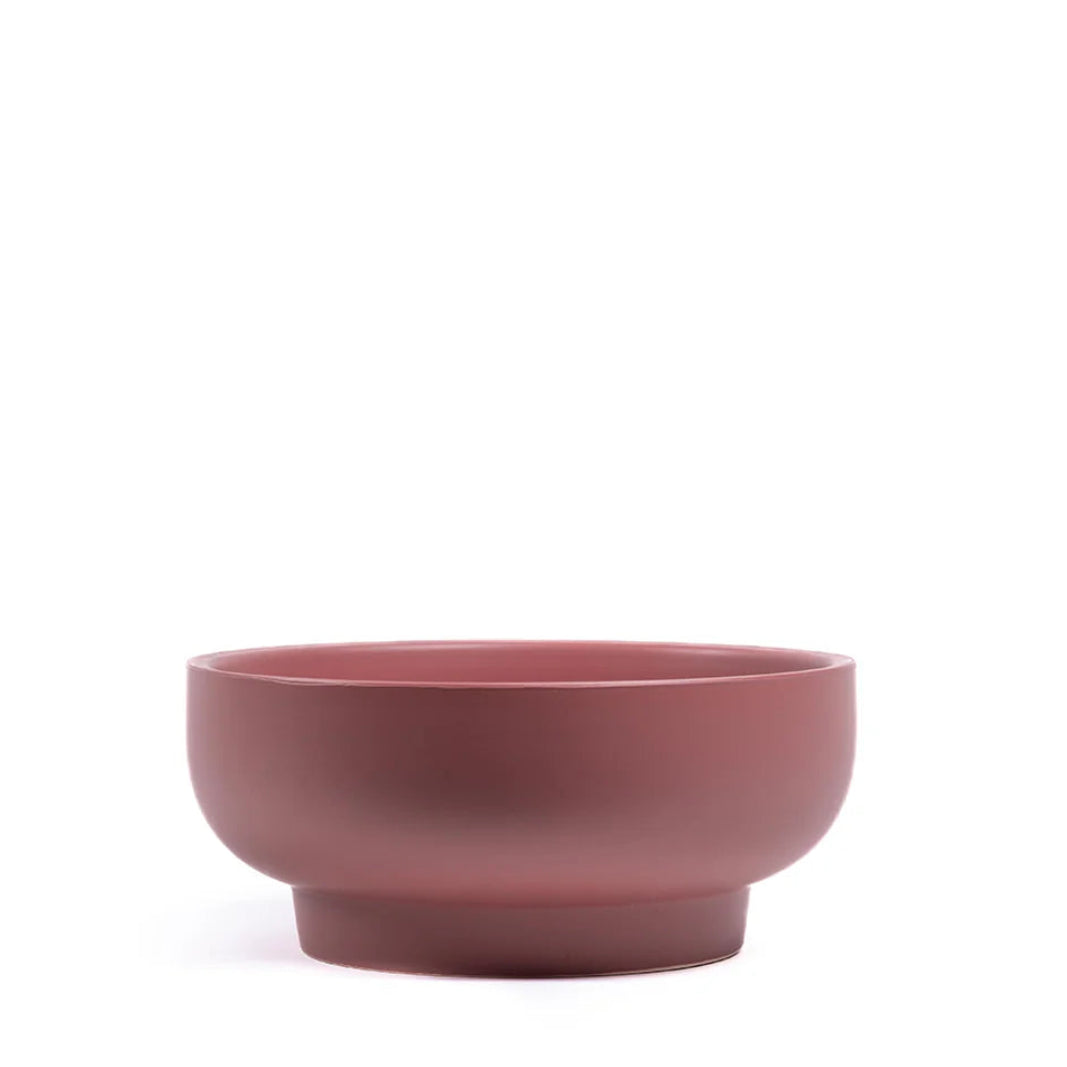 Dusty rose ceramic bowl on a white background