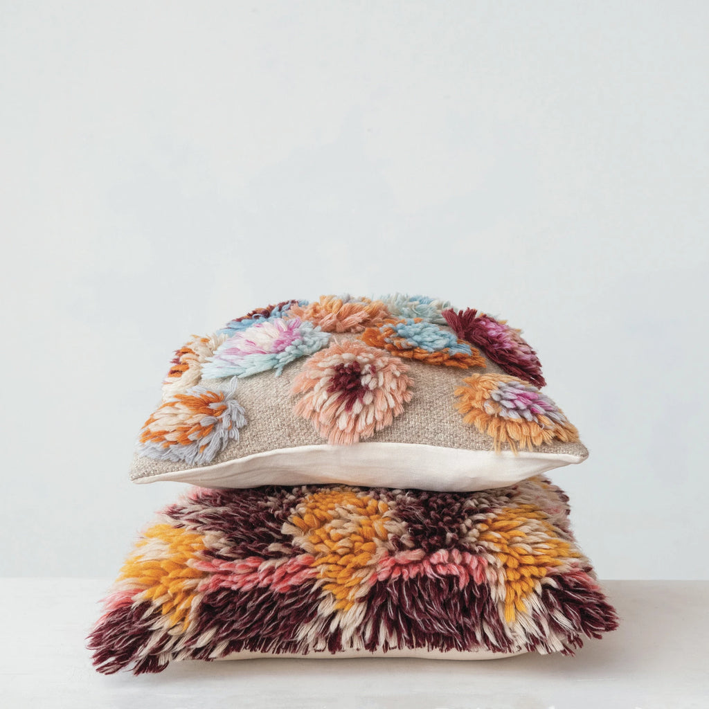 Stacked multicolor wool pillows with shag and floral textured patterns for home decor and sofa accents