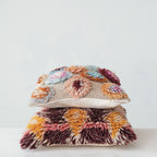 Stacked multicolor wool pillows with shag and floral textured patterns for home decor and sofa accents