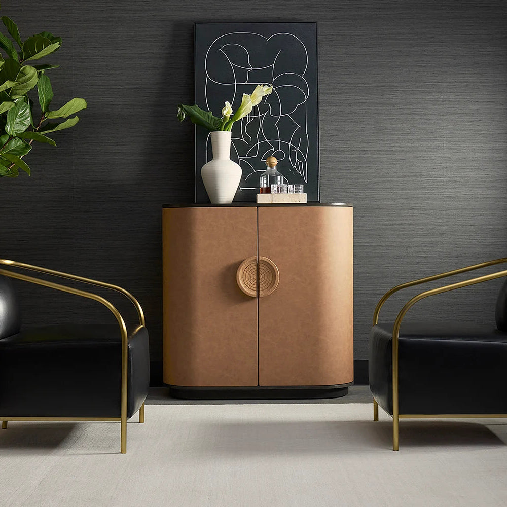 Modern interior with a brown cabinet, black chairs, and decorative elements against a dark wall.