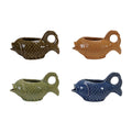 Four fish-shaped ceramic creamers in different colors on a white background