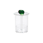 Clear glass toothpick holder with a green olive-shaped handle on top, minimalist home decor accessory.
