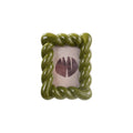 Green rope-style picture frame with a white background