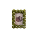 Green rope-style picture frame with a white background