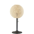 A modern table lamp with a spherical, woven beige shade and a dark metal stem on a solid white background.
