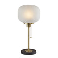 Modern table lamp with frosted ribbed glass shade, brass stem, and dark round base with pull chain switch