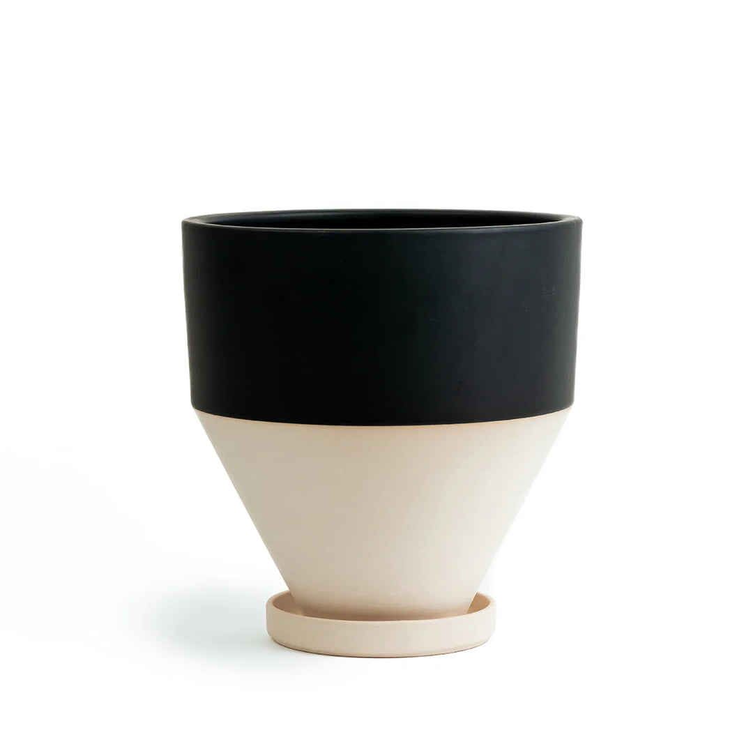 Half black and beige  ceramic pot with drip tray on a white background