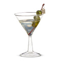 Martini glass with olive and cocktail cherry on a white background
