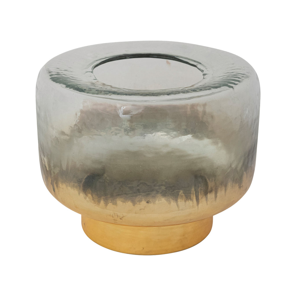 Glass candle holder with gold base on a white background