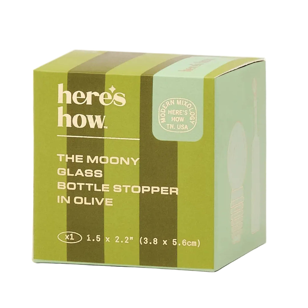 Green box packaging for 'The Moony Glass Bottle Stopper' with brand name 'here's how'.