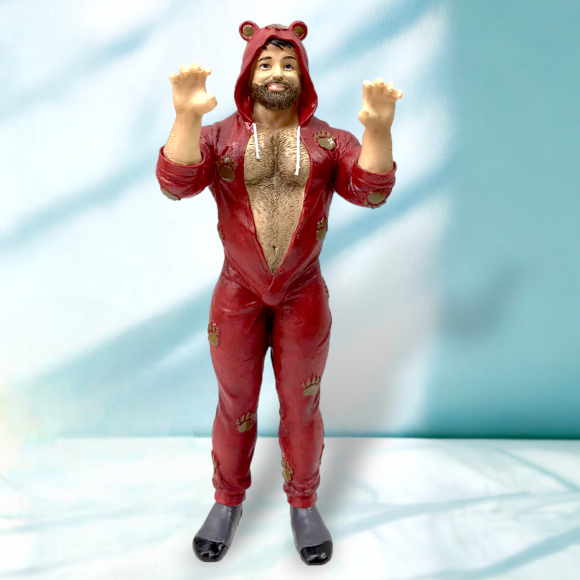 Figurine of a bearded man wearing a red bear-themed onesie with raised arms and paw prints on the fabric.