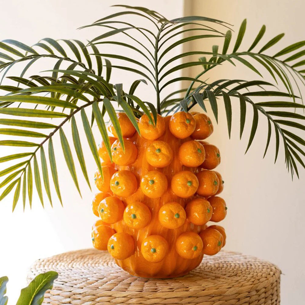large orange vase with oranges on it