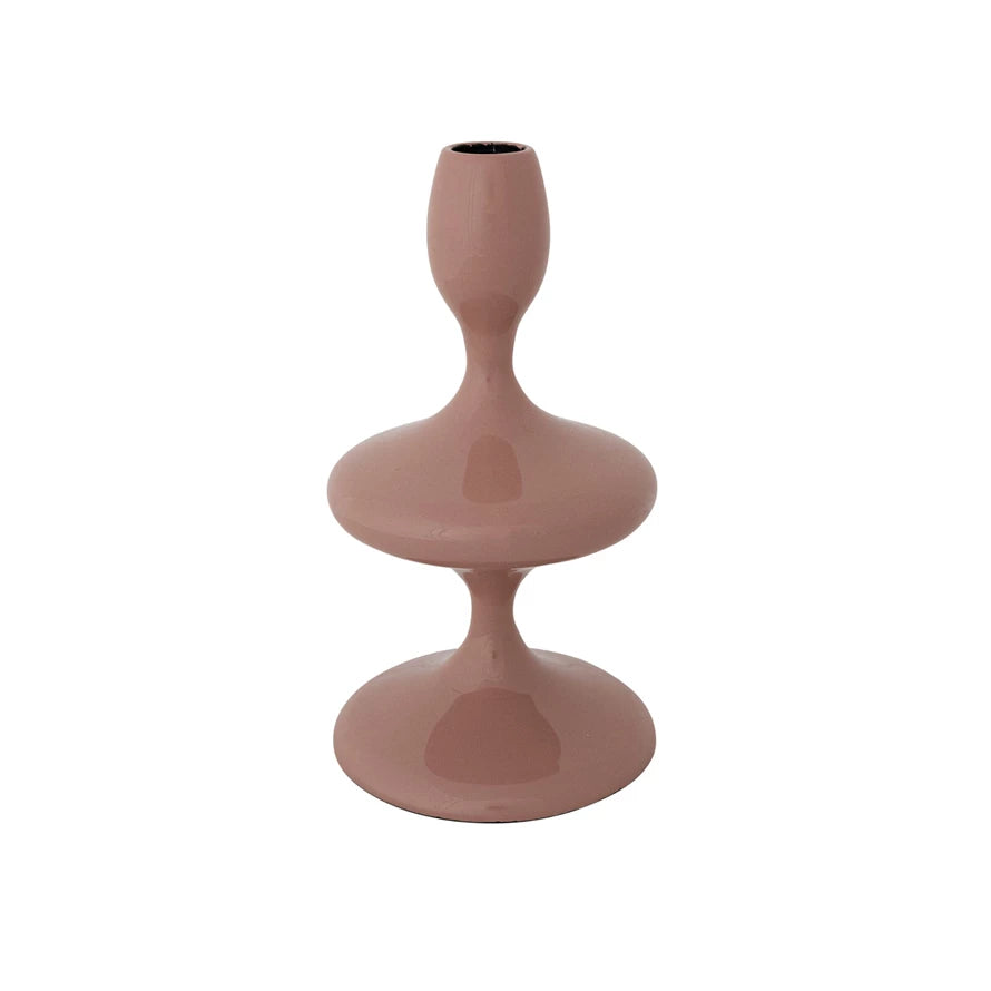 Pink enameled cast aluminum taper holder with a modern, sculptural design for home decor and candles.