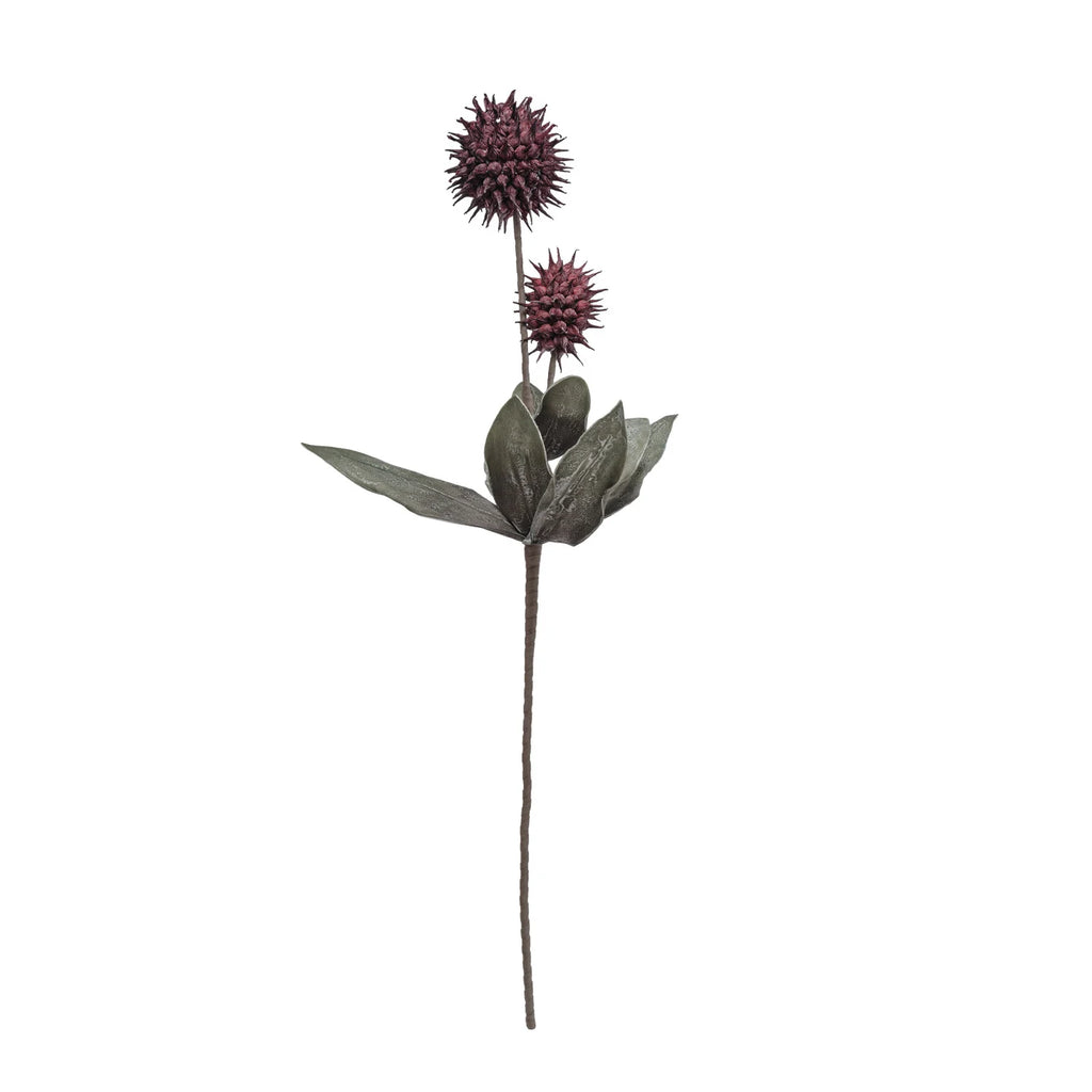 Artificial plant with purple flowers and green leaves on a white background