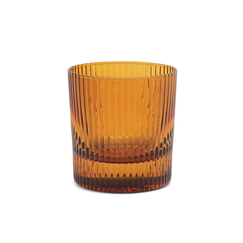 An amber-colored glass tumbler with a ribbed, vertically fluted design, shown on a solid white background.