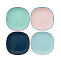 Four colorful square plates on a white background