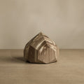 Wooden block with geometric design on a beige background