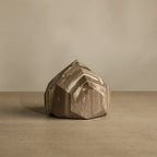 Wooden block with geometric design on a beige background