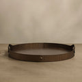 Bronze decorative tray on a beige surface with a beige background