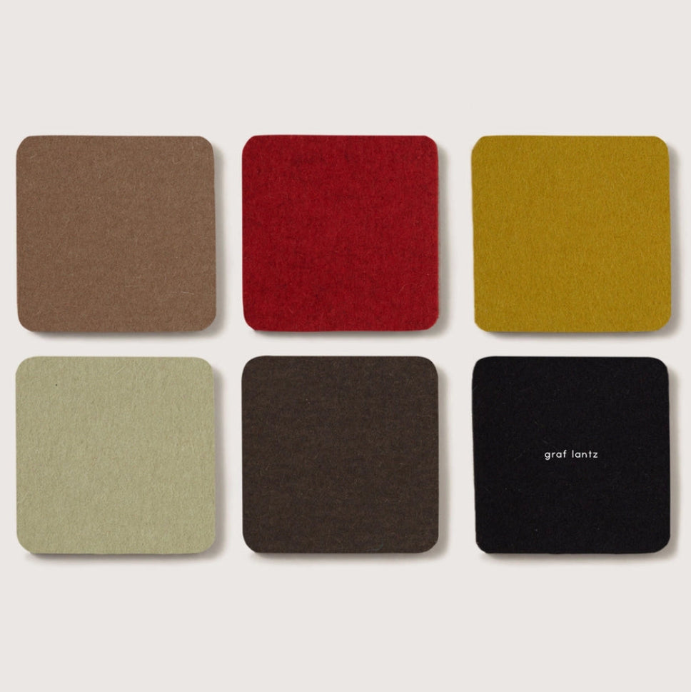 Six square color swatches in brown, red, yellow, green, gray, and black on a light beige background.