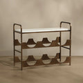 A mid-century modern metal shoe rack with a white upholstered seat and a bronze-finished frame, set against a warm beige background.